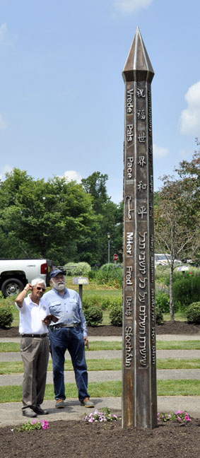 Large Stainless Peace Pole with people next to it for perspective