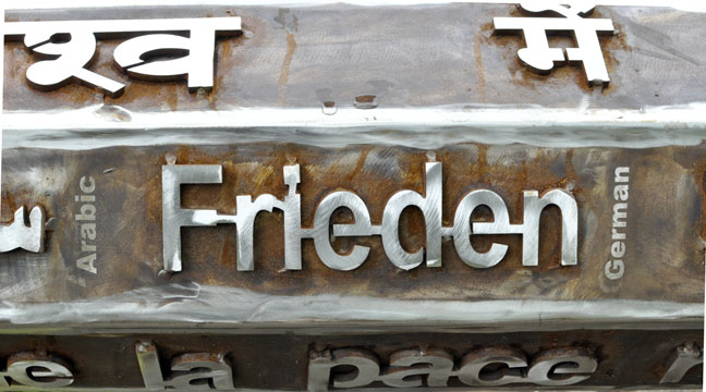 Raised text on a peace pole