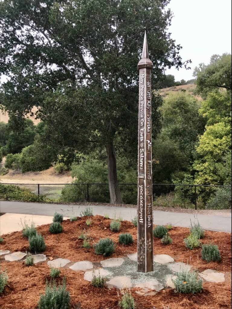 12 foot tall stainless peace pole with raised text