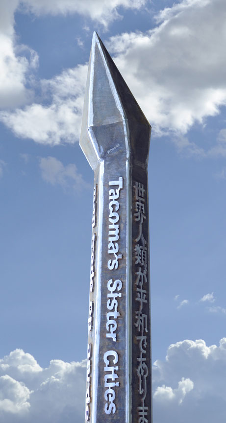 Stainless peace pole with cap set akilter